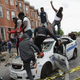 Demonstrators climb on a destroyed Baltimore police car in the street near the corner of Pennsylvania and North avenues during protests following the funeral of Freddie Gray April 27, 2015, in Baltimore.
Chip Somodevilla/Getty Images